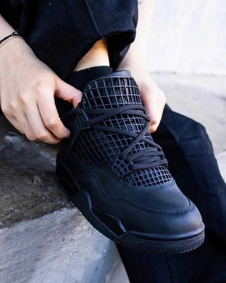 Jordan 4 RetroNet Black running in a subway station area shoes